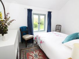 A bedroom with a bed and window at Rhos Y Clegryn in Goodwick