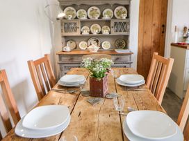 A dining room with a table set for four at Rhos Y Clegyrn in Goodwick
