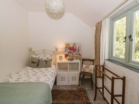 A bedroom with a bed and a chair at Rhos Y Clegyrn Goodwick