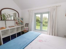 A bedroom with a bed and a window at Rhos Y Clegyrn Goodwick