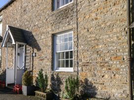 An exterior view of a stone cottage with a window and door at Englewood Cottage Hexham