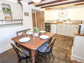 A kitchen with a dining table set for dinner at Englewood Cottage Hexham