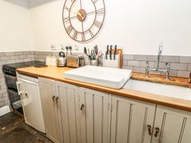 A kitchen with a sink and appliances at Englewood Cottage in Hexham