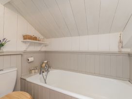 A bathroom with a bath tub and toilet at Englewood Cottage in Allenheads