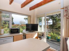 A kitchen with a refrigerator and microwave at Flat 1 Lee Cliff Park, Dawlish Warren