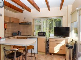 A kitchen with appliances and a table at Flat 1 Lee Cliff Park Dawlish Warren