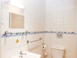 A bathroom with a mirror, sink and toilet at Flat 1 Lee Cliff Park, Dawlish Warren