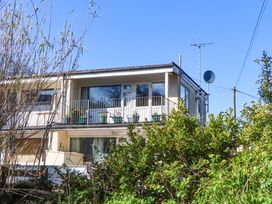 A building with a balcony and satellite dish at Flat 1 Lee Cliff Park Dawlish Warren