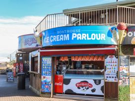 An ice cream parlour sign with menus and a counter at Boathouse in Dawlish Warren
