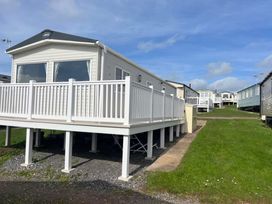 A mobile home with a deck at 52 Juniper Close Exmouth