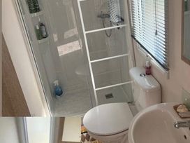 A bathroom with a shower, toilet and sink at 52 Juniper Close Exmouth
