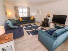 A living room with sofas and a fireplace at Rosevale Villa St Ives