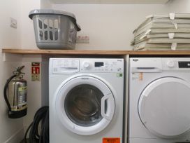 A laundry room featuring a washing machine and a tumble dryer at Rosevale Villa St Ives