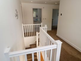 A hallway with a staircase and handrail at Rosevale Villa St Ives