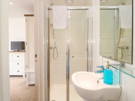 A bathroom with a shower and sink at Rosevale Villa St Ives