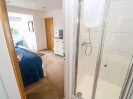 A bedroom with a shower visible from the doorway at Rosevale Villa St Ives