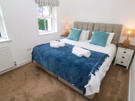 A bedroom with a bed and bedside tables at Rosevale Villa in St Ives