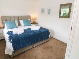 A bedroom with a bed and bedside lamp at Rosevale Villa in St Ives