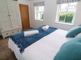 A bedroom with a bed and wardrobe at Rosevale Villa St Ives