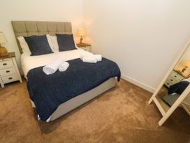 A bedroom with a bed and a lamp at Rosevale Villa St Ives