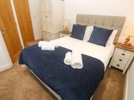 A bedroom with a bed and wardrobe at Rosevale Villa St Ives