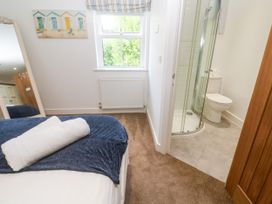 A bedroom with a bed and attached bathroom at Rosevale Villa St Ives