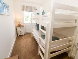 A bedroom with a bunk bed and a nightstand at Rosevale Villa St Ives