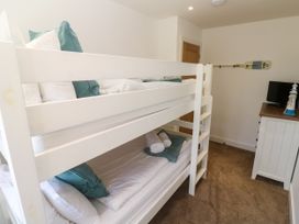 A bedroom with a bunk bed and dresser at Rosevale Villa St Ives