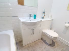 A bathroom with a sink, toilet, and bath tub at Rosevale Villa St Ives