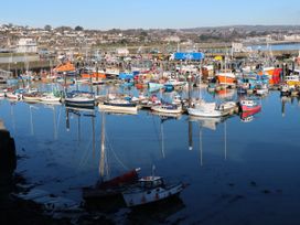 A harbor filled with boats reflected in the water at Rosevale Villa, St Ives