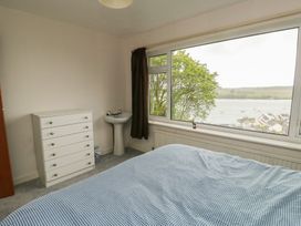 A bedroom with a bed and a window at Bryn Y Felin in Y Felinheli