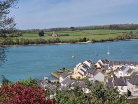 A view of houses and boats along a river at Bryn Y Felin in Y Felinheli