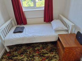 A bedroom with a single bed and bedside table at Bryn Y Felin in Y Felinheli