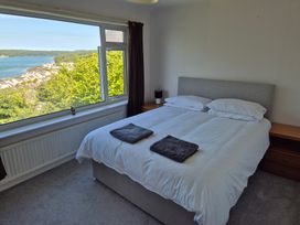 A bedroom with a bed and bedside table at Bryn Y Felin in Y Felinheli