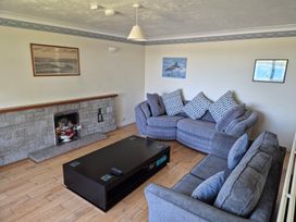 A living room with a sofa and coffee table at Bryn Y Felin in Y Felinheli