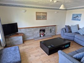 A living room with a television and sofa at Bryn Y Felin in Y Felinheli
