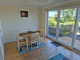 A dining room with a table and chairs at Bryn Y Felin in Y Felinheli