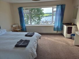 A bedroom with a bed and a window view at Bryn Y Felin, Y Felinheli
