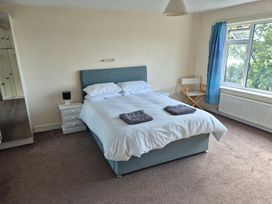 A bedroom with a bed and a window at Bryn Y Felin Y Felinheli