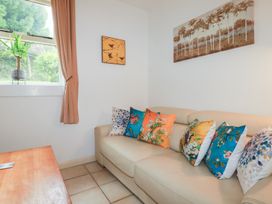 A snug with a sofa and cushions at Plenteth in Truro