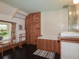 A bathroom with a bathtub and sink at Plenteth in Truro