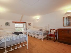 A bedroom with two beds and a dresser at Plenteth in Truro