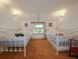 A bedroom with two beds and a window at Plenteth, Truro