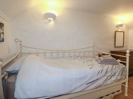 A bedroom with a bed and nightstand at Plenteth in Truro