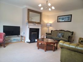 A living room with a television and sofa at 16 Forth An Nance in Portreath