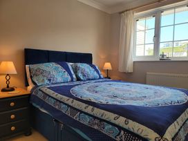 A bedroom with a bed and nightstand at 16 Forth An Nance, Portreath