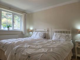 A bedroom with twin beds and a window at 16 Forth An Nance in Portreath