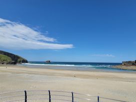 A beach with sand and water at 16 Forth An Nance in Portreath