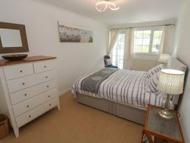 A bedroom with a bed and dresser at 16 Forth An Nance in Portreath