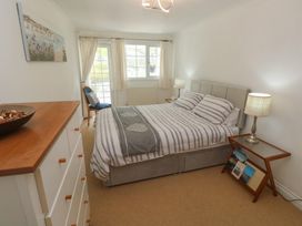 A bedroom with a bed and dressing table at 16 Forth An Nance in Portreath